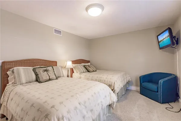 a bedroom with two beds and a couch