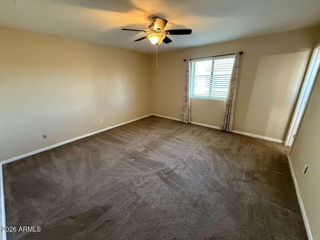 3110 East 13th Street Douglas, AZ 85607 - Photo 22 of 42 an empty room with windows and fan
