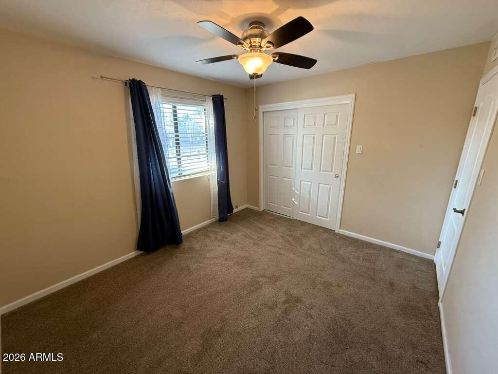 3110 East 13th Street Douglas, AZ 85607 - Photo 24 of 42 an empty room with windows and fan