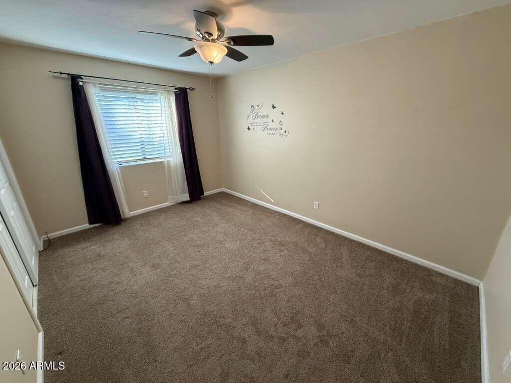 3110 East 13th Street Douglas, AZ 85607 - Photo 25 of 42 an empty room with windows and fan