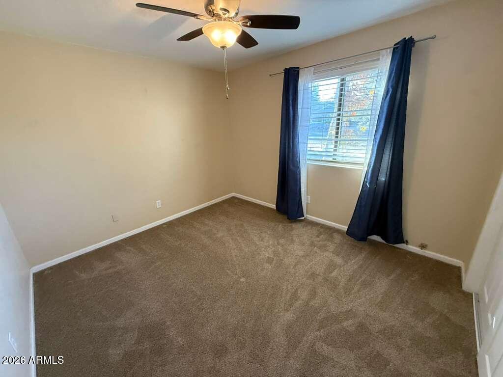 3110 East 13th Street Douglas, AZ 85607 - Photo 27 of 42 an empty room with windows and fan