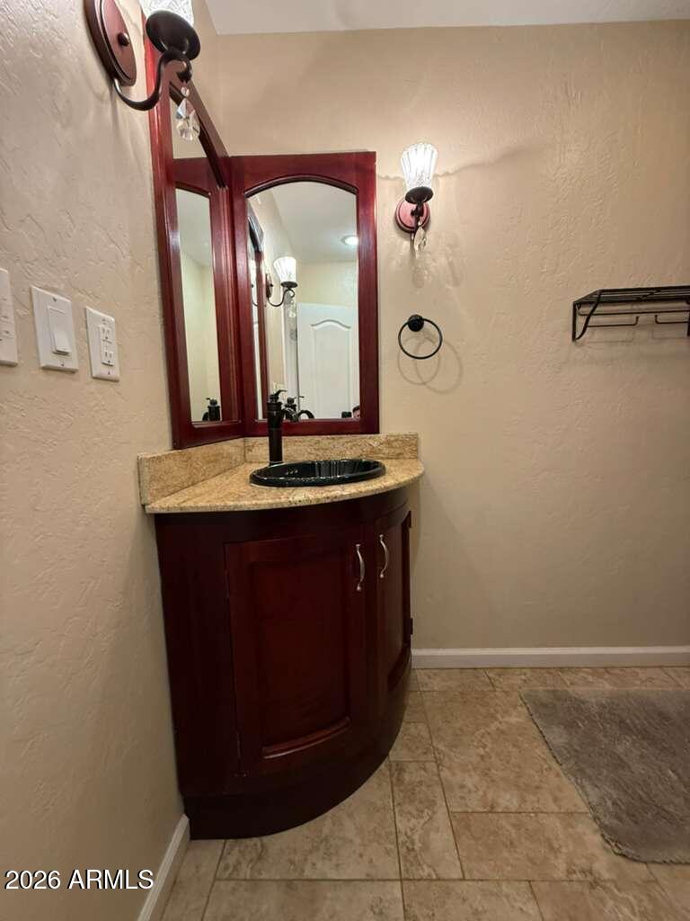 3110 East 13th Street Douglas, AZ 85607 - Photo 29 of 42 a bathroom with a sink a vanity and a mirror