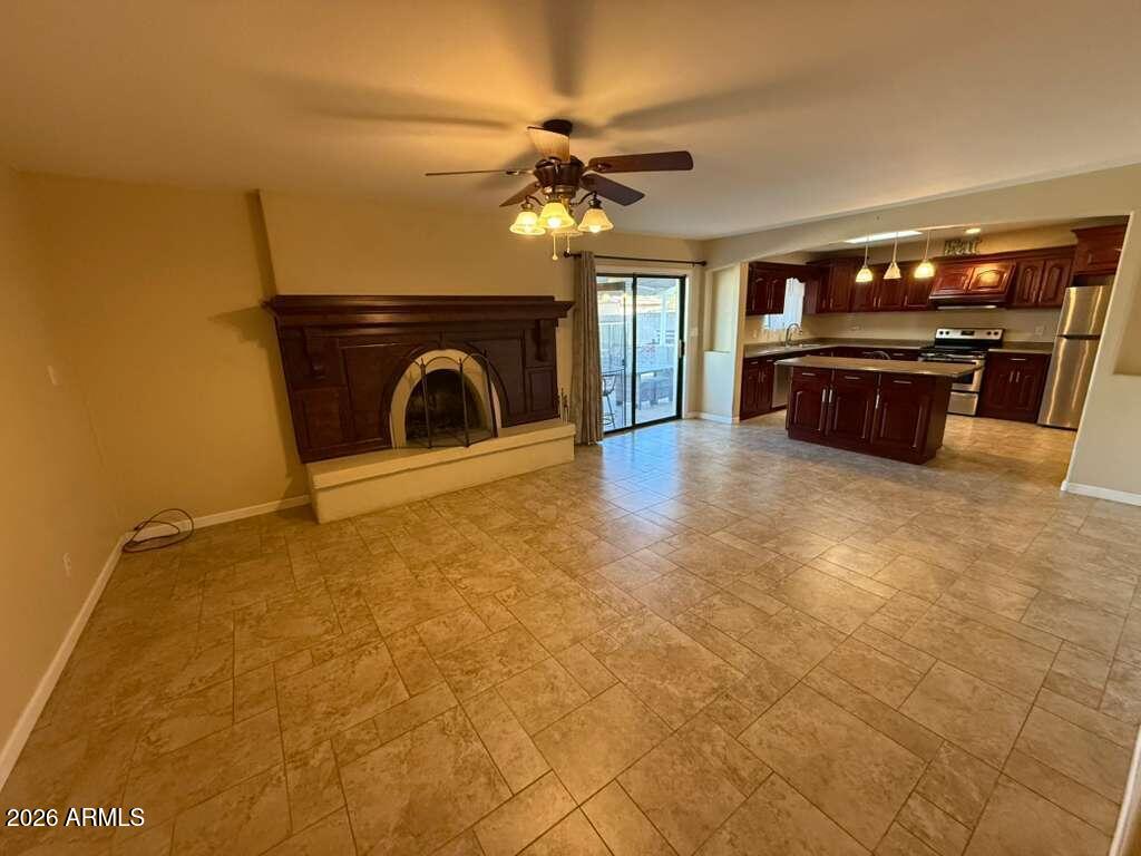 3110 East 13th Street Douglas, AZ 85607 - Photo 32 of 42 a view of a livingroom with a fireplace and a ceiling fan