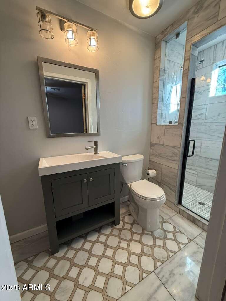 3110 East 13th Street Douglas, AZ 85607 - Photo 8 of 42 a bathroom with a sink mirror and toilet