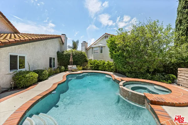 a swimming pool with outdoor seating and yard