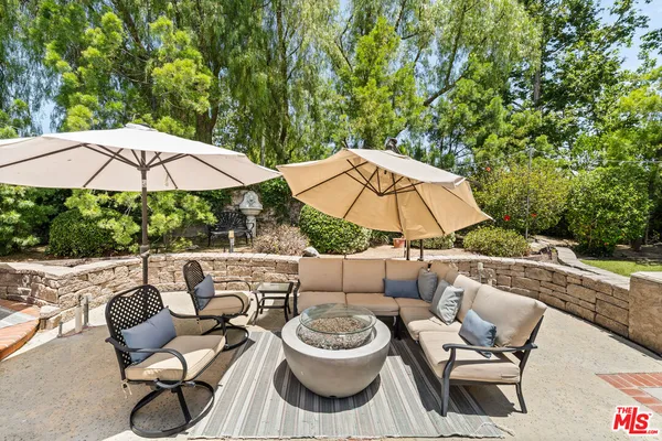 a patio with a patio table and chairs