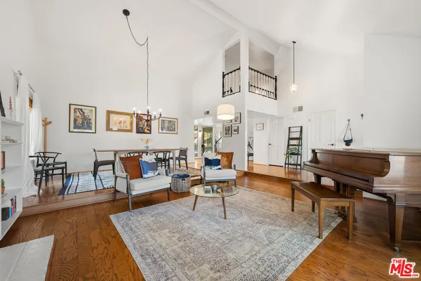 a living room with furniture wooden floor and a table