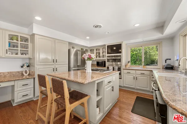 a kitchen with appliances cabinets and a counter top space