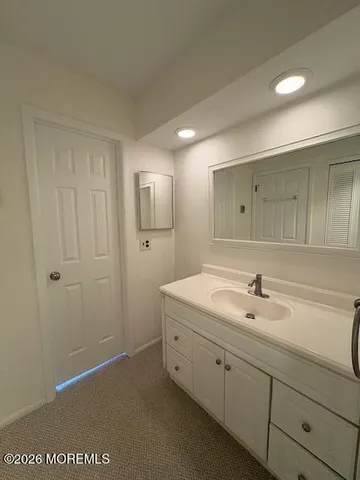 a bathroom with a double vanity sink and mirror
