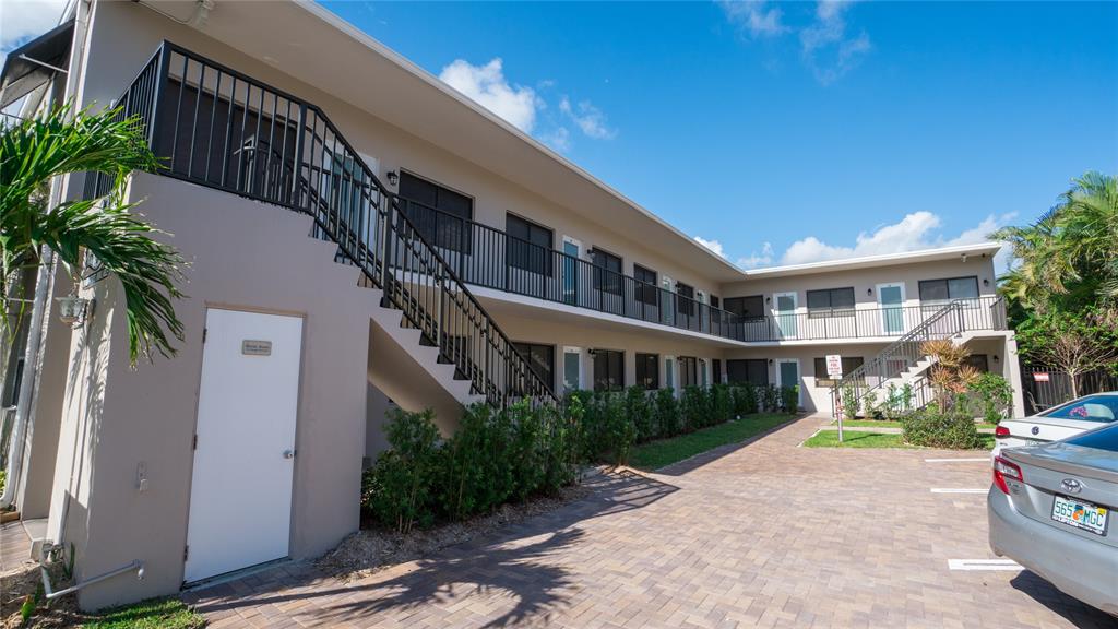 2621 Northeast 1st Street, Unit 10 Pompano Beach, FL 33062 - Photo 6 of 9 a view of building with yard