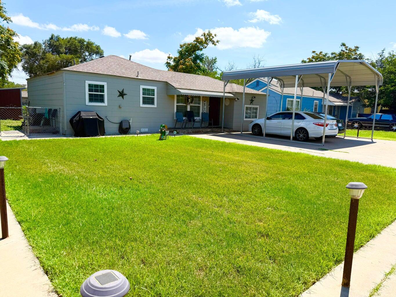 a view of a house with backyard porch and furniture