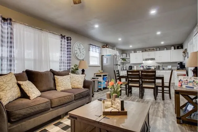 a living room with furniture and kitchen view