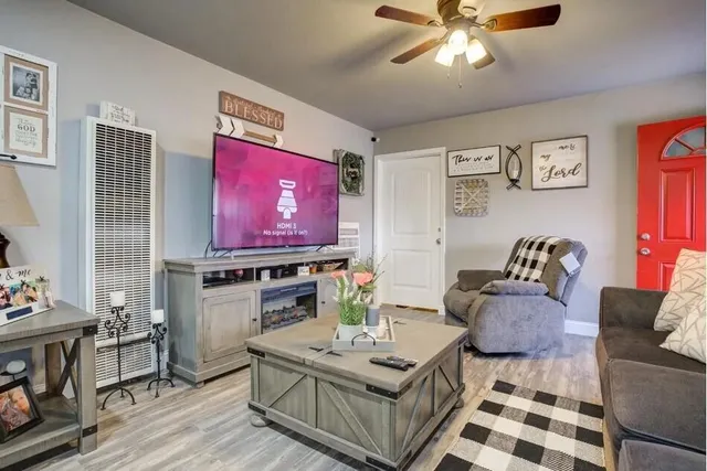 a living room with furniture and a flat screen tv