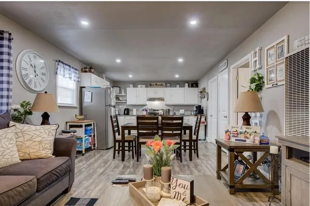a living room with lots of furniture and kitchen view