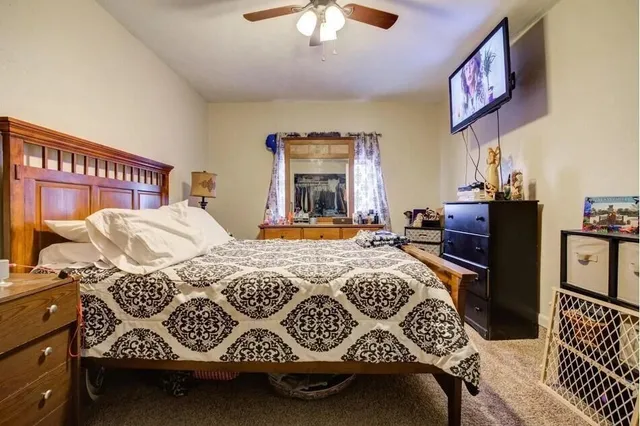 a bedroom with a bed and a chandelier