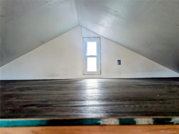a view of room and hall with wooden floor