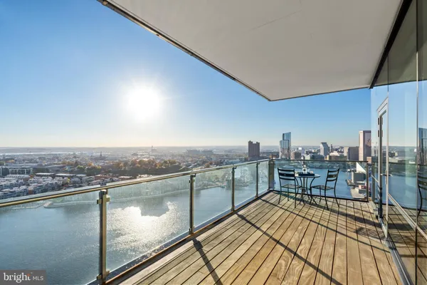 a view of a balcony with wooden floor and outdoor seating