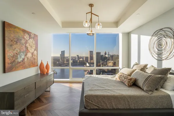a bedroom with a large bed and a chandelier