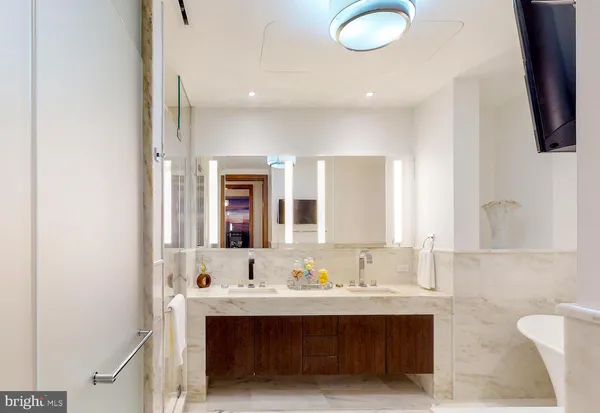 a bathroom with a sink double vanity and a mirror