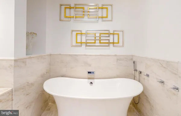 a white bath tub sitting in a bathroom