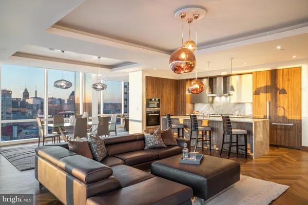 a living room with furniture a chandelier and a large window