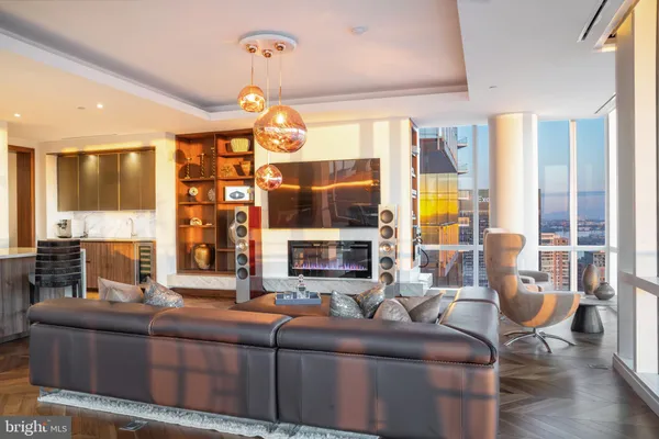 a living room with fireplace furniture and a large window
