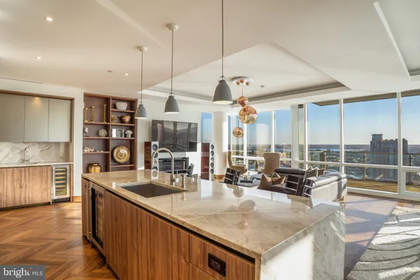 a kitchen with a stove a counter space a sink and cabinets