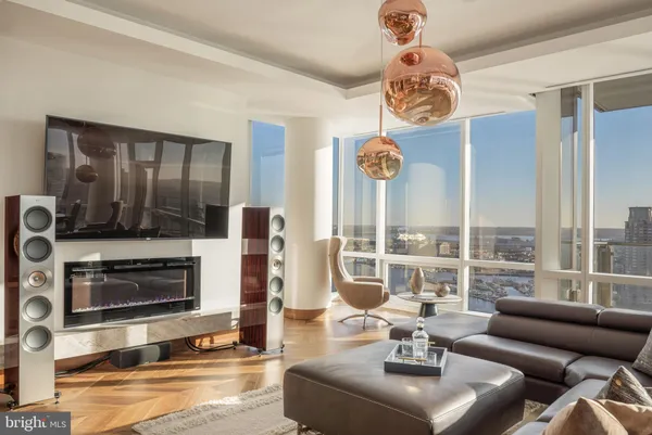 a living room with fireplace furniture and a floor to ceiling window