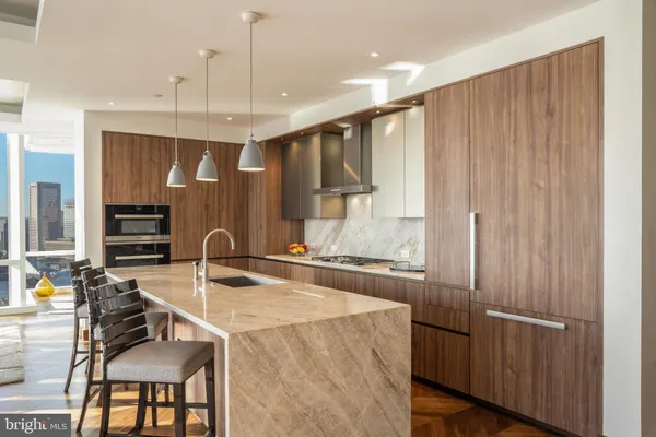 a kitchen with kitchen island granite countertop a sink and counter space