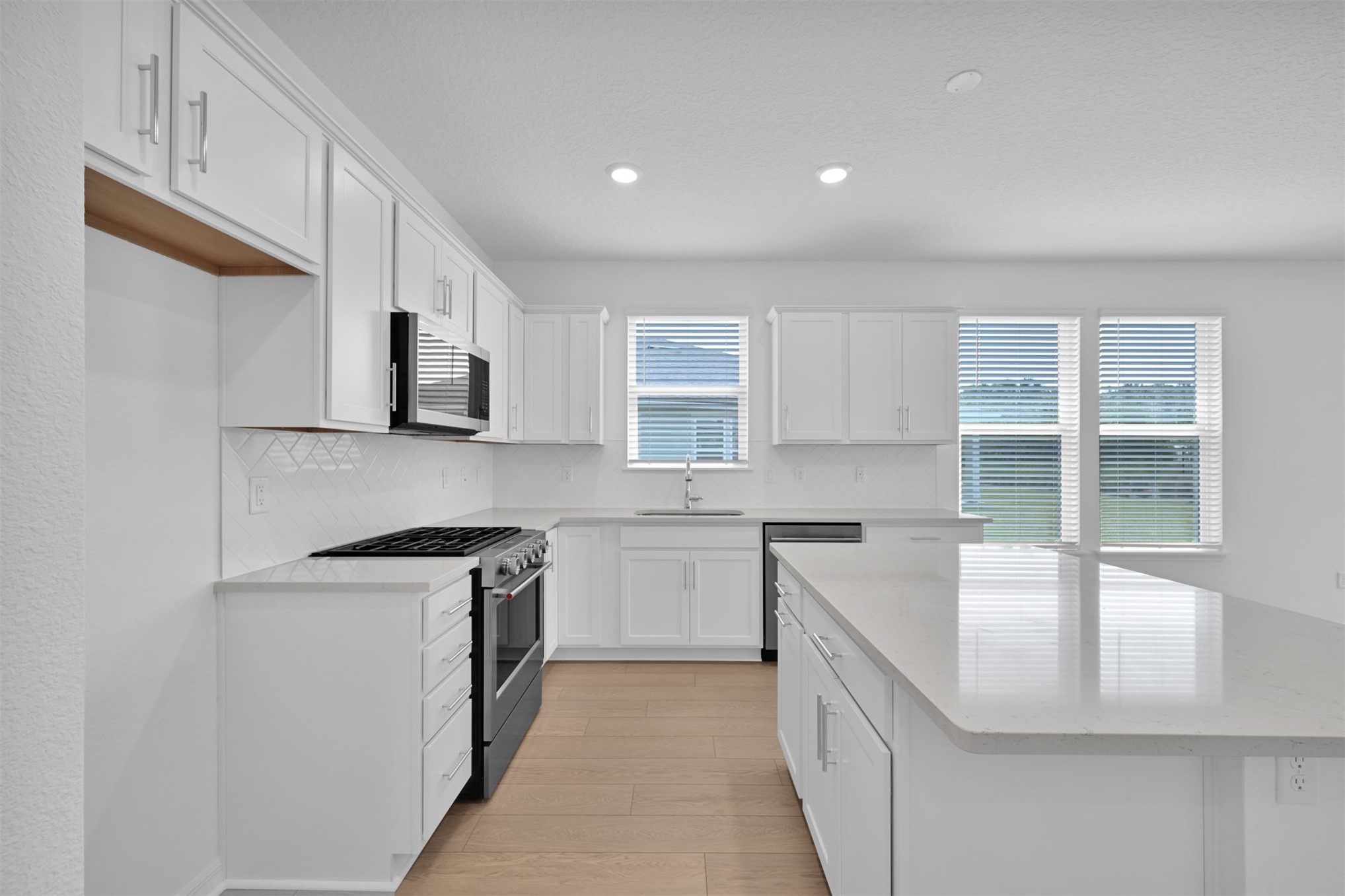 328 Ecliptic Loop Yulee, FL 32097 - Photo 7 of 41 a kitchen with stainless steel appliances a sink stove and cabinets