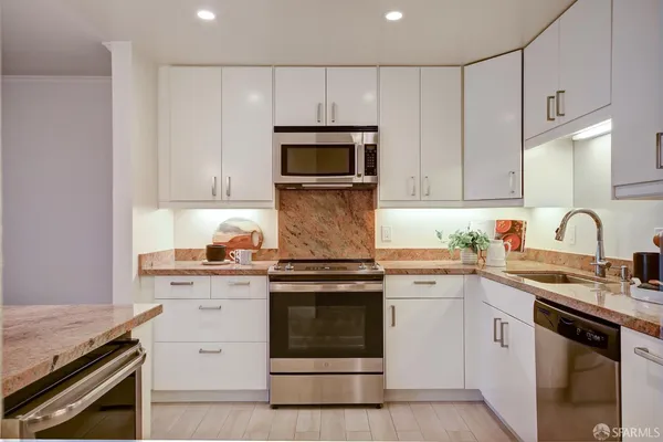 a stove top oven sitting inside of a kitchen