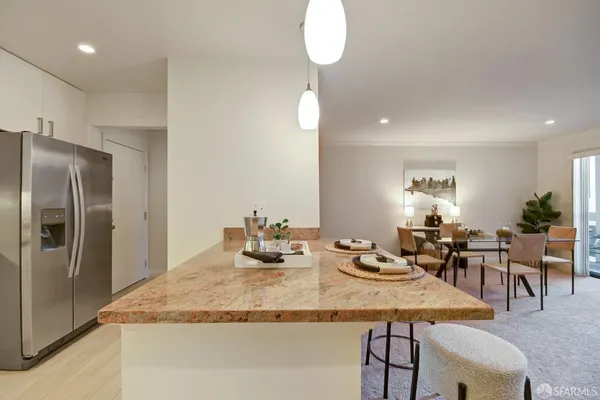 a kitchen with a refrigerator and a stove