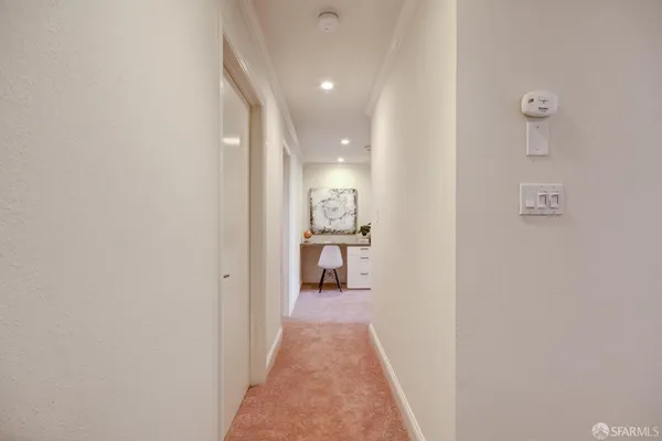 a living room with furniture a potted plant and a large window