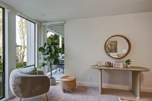 a living room with furniture and a potted plant