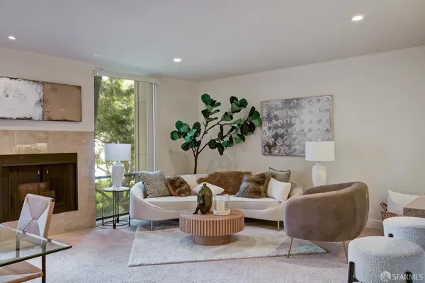 a living room with furniture and a potted plant