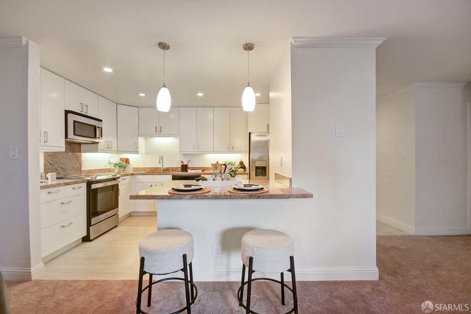 1171 Compass Lane, Unit 209 Foster City, CA 94404 - Photo 8 of 55 a kitchen with white cabinets and stainless steel appliances