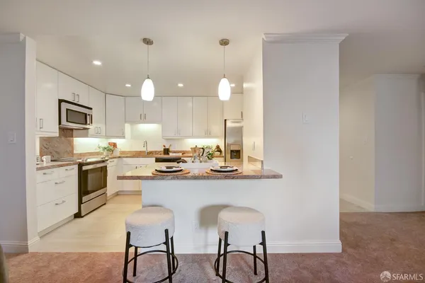 a kitchen with a sink stove and cabinets