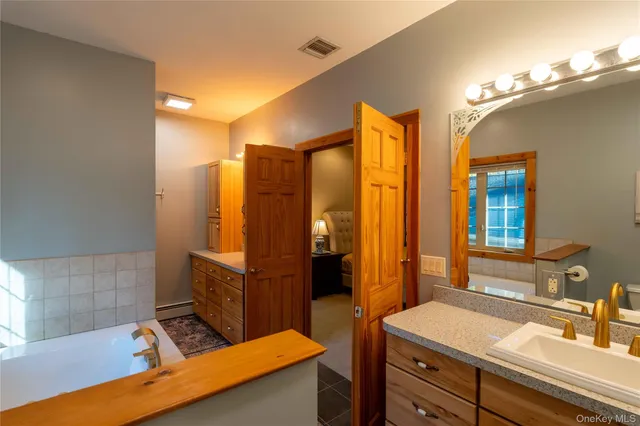 a bathroom with a sink double vanity and a mirror