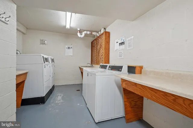 a spacious bathroom with a granite countertop sink and a mirror