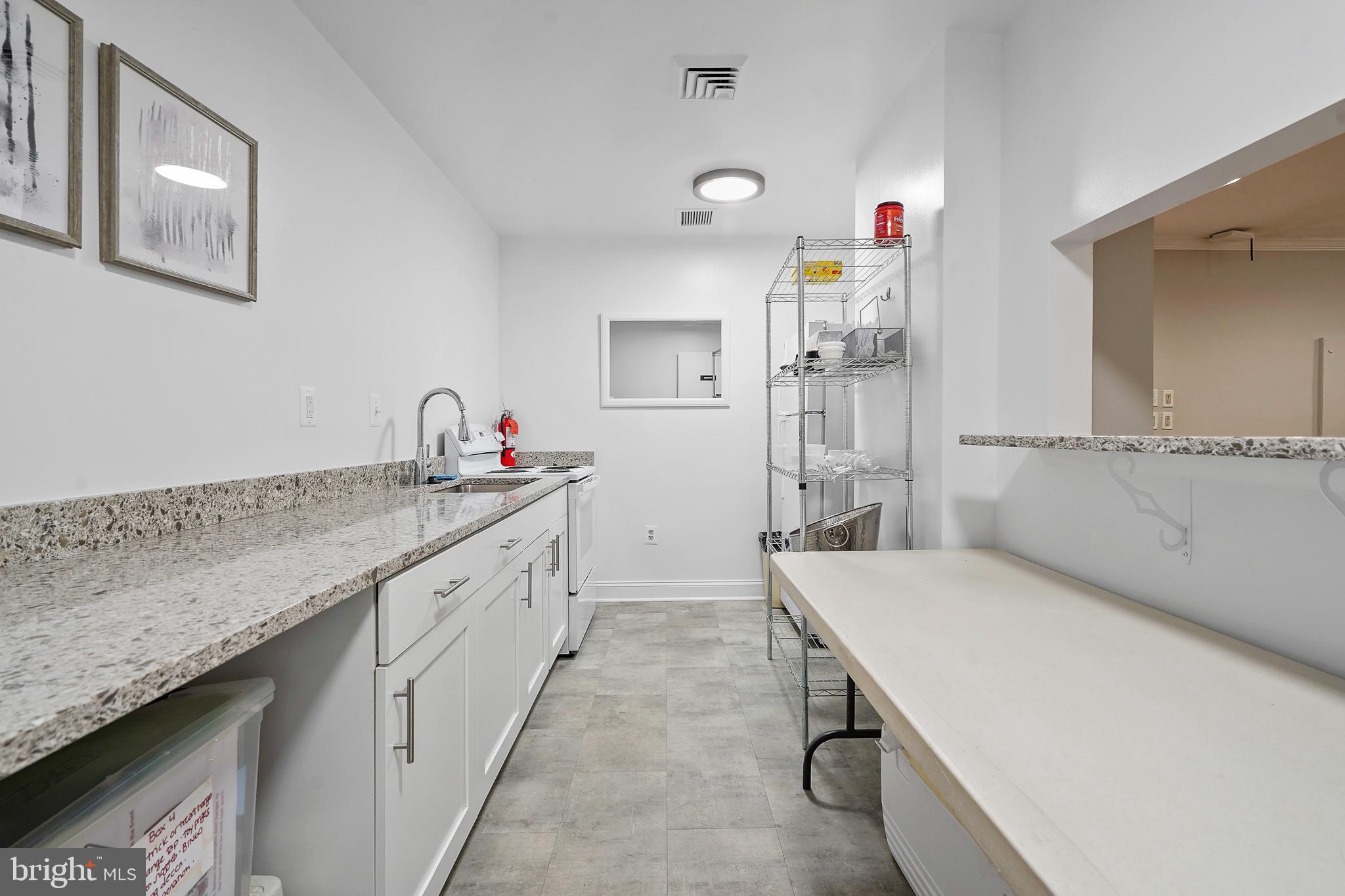1225 Martha Custis Drive, Unit 1119 Alexandria, VA 22302 - Photo 30 of 36 a spacious bathroom with a granite countertop sink and a mirror