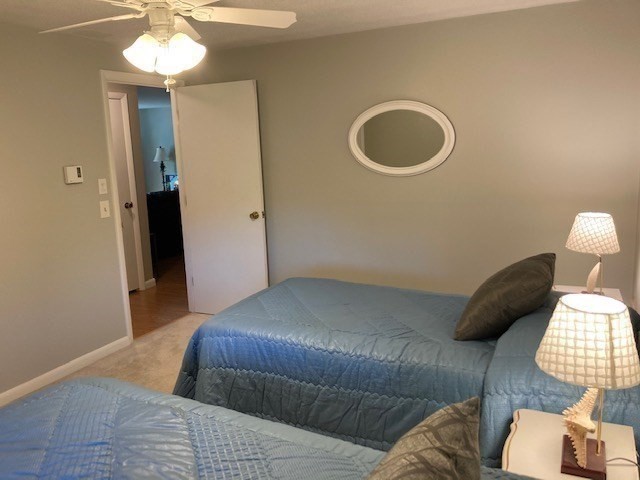 91 Pleasant Street, Unit D6 Medfield, MA 02052 - Photo 12 of 14 a bedroom with a bed and a chandelier