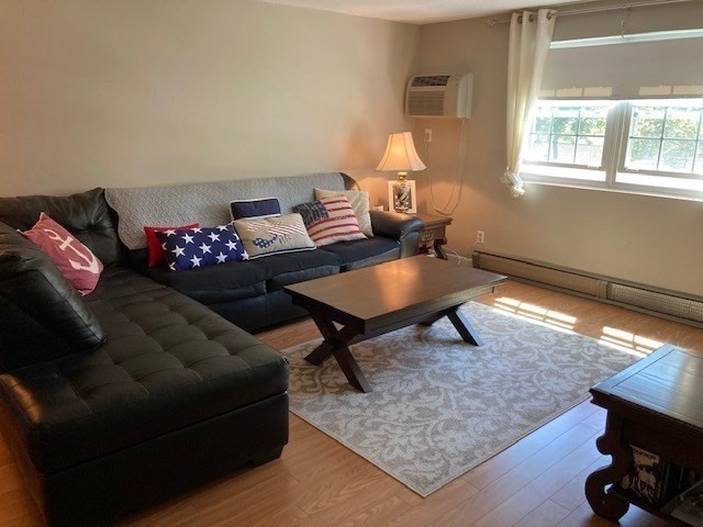 91 Pleasant Street, Unit D6 Medfield, MA 02052 - Photo 4 of 14 a living room with furniture and a window