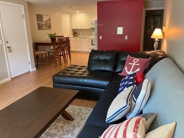 91 Pleasant Street, Unit D6 Medfield, MA 02052 - Photo 6 of 14 a living room with furniture and a lamp