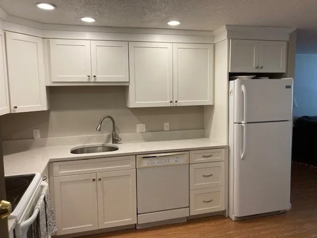 a kitchen with appliances cabinets and a sink