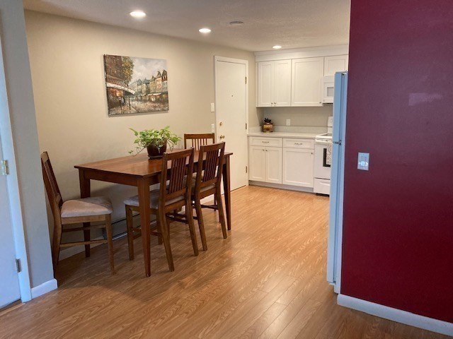 91 Pleasant Street, Unit D6 Medfield, MA 02052 - Photo 9 of 14 a view of kitchen with cabinets and wooden floor