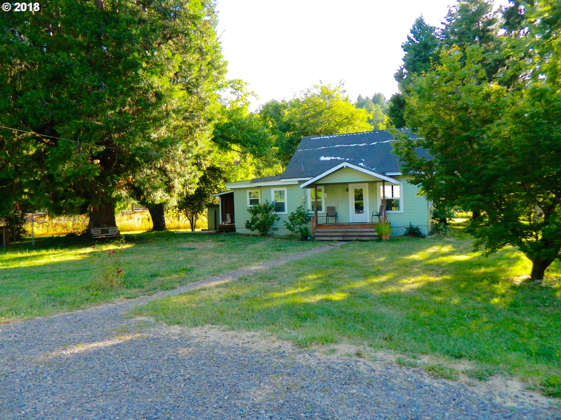 38323 Wheeler Road Dexter, OR 97431 - Photo 2 of 32 a front view of house with yard and green space