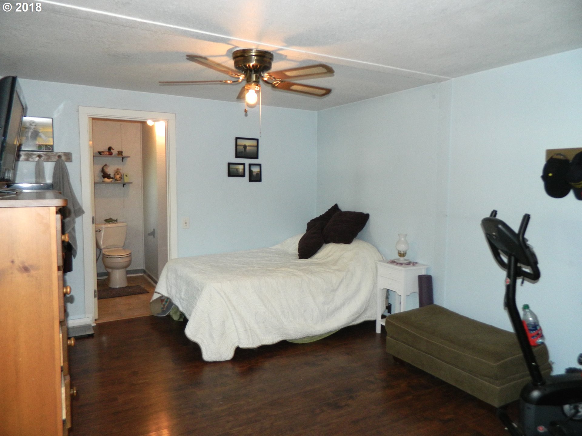 38323 Wheeler Road Dexter, OR 97431 - Photo 25 of 32 a bedroom with a bed and wooden floor