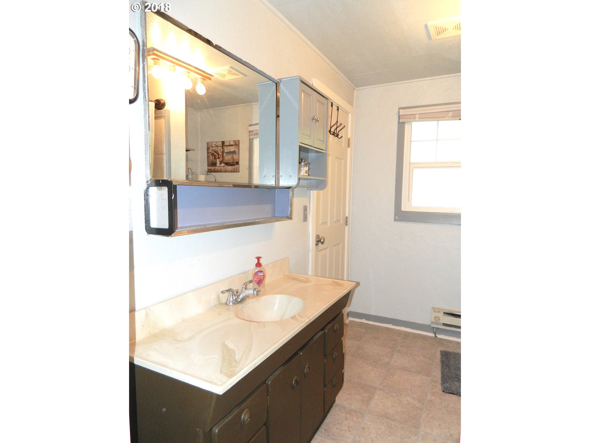 38323 Wheeler Road Dexter, OR 97431 - Photo 27 of 32 a bathroom with a sink and a mirror