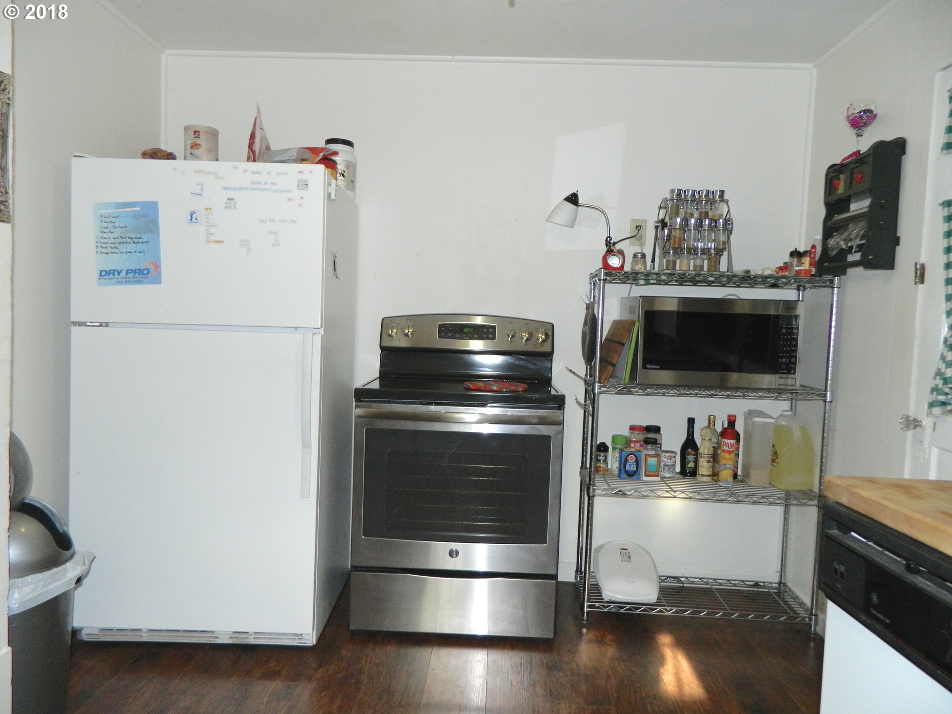 38323 Wheeler Road Dexter, OR 97431 - Photo 30 of 32 a kitchen with a refrigerator and a stove top oven
