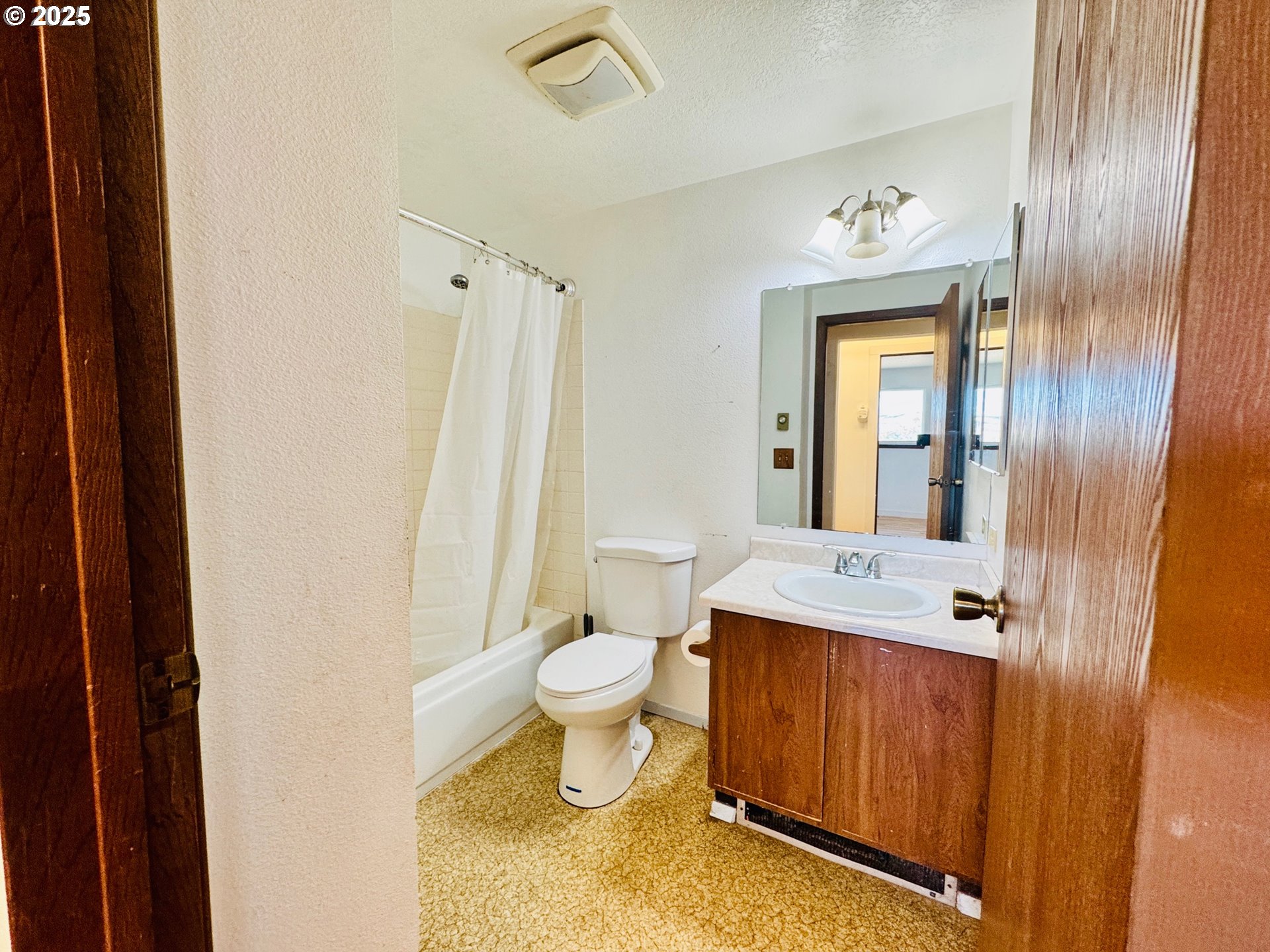 1275 West 1st Street Arlington, OR 97812 - Photo 15 of 24 a bathroom with a sink mirror vanity and toilet